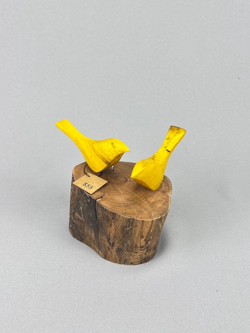 Yellow birds on stump