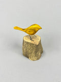 Yellow bird on stump
