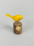 Yellow bird on stump